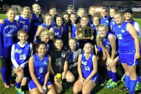 The LCHS Girls' Soccer Team celebrates their sectional championship October 21.