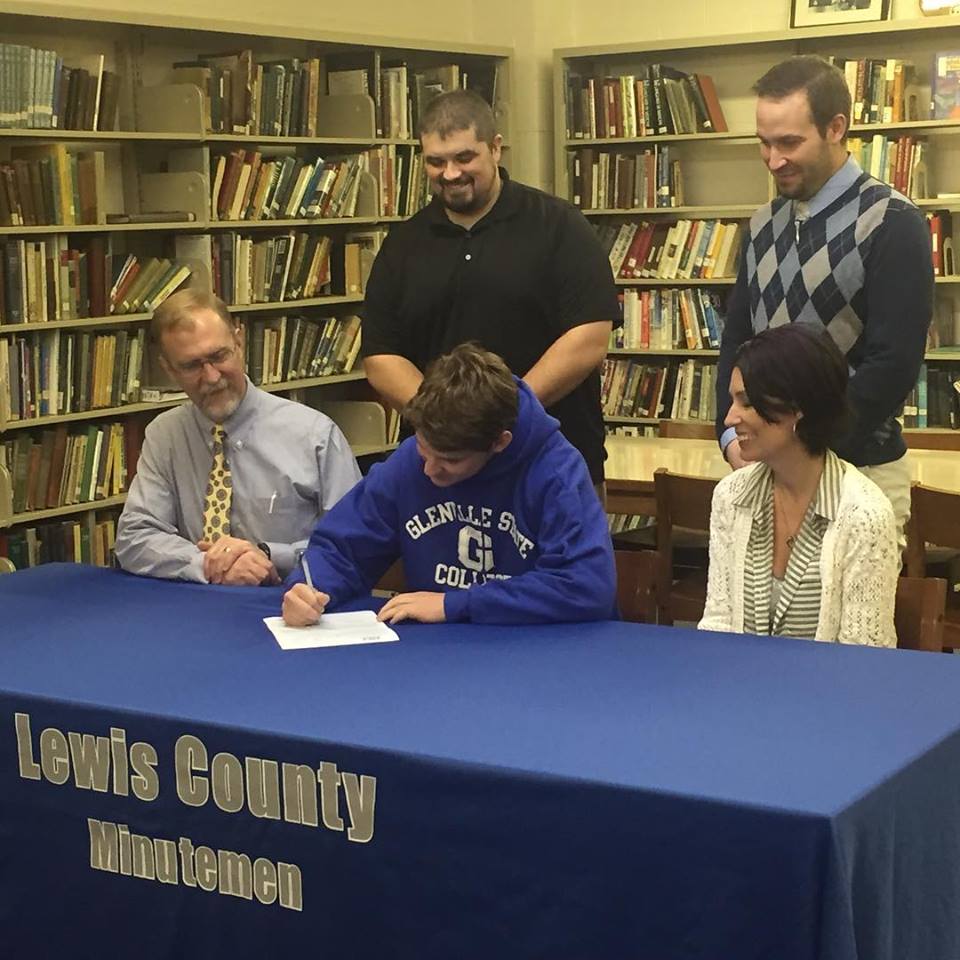 Riley Gunter signs his letter of intent with GSC in National Signing Day festivities at LCHS.  Gunter signs while his mother, Jena Whiston, and his step-father, John Whiston look on.
