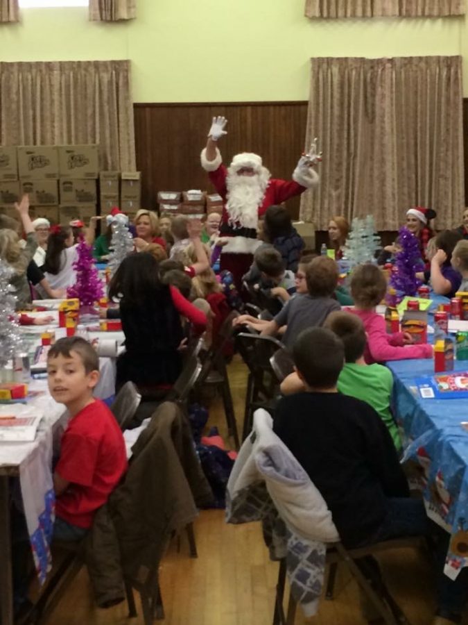 Santa greets elementary students during the Annual Rotary Christmas Dinner.  LCHS Interact members assisted with the dinner.