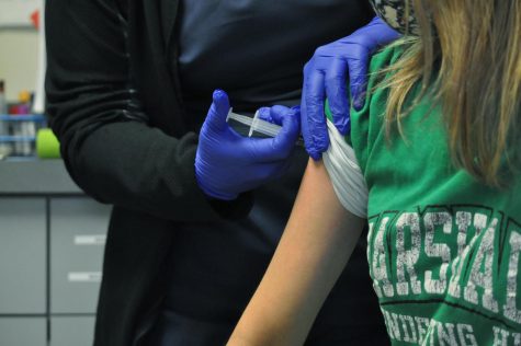 A young adult receives a vaccine earlier this month.