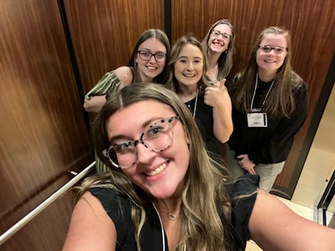 Officers and adviser, Mrs. Lough, take a picture in the elevator at the Waterfront Marriott Hotel in Morgantown during the fall conference.